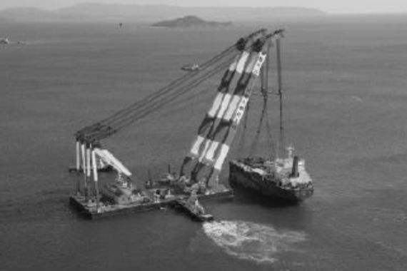 Salvaging the Co-op Venture remains with a crane ship