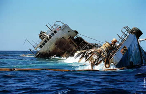 The Jessica wreck surrounded with antipollution booms