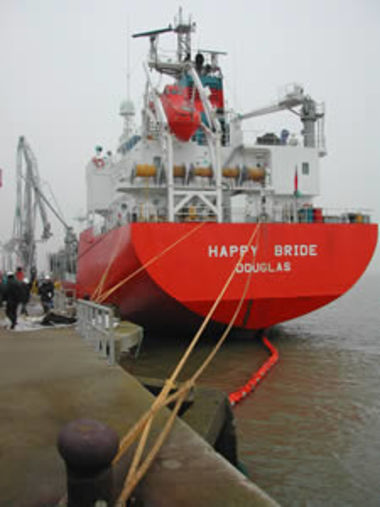 The Happy Bride alongside the quay surrounded by a boom